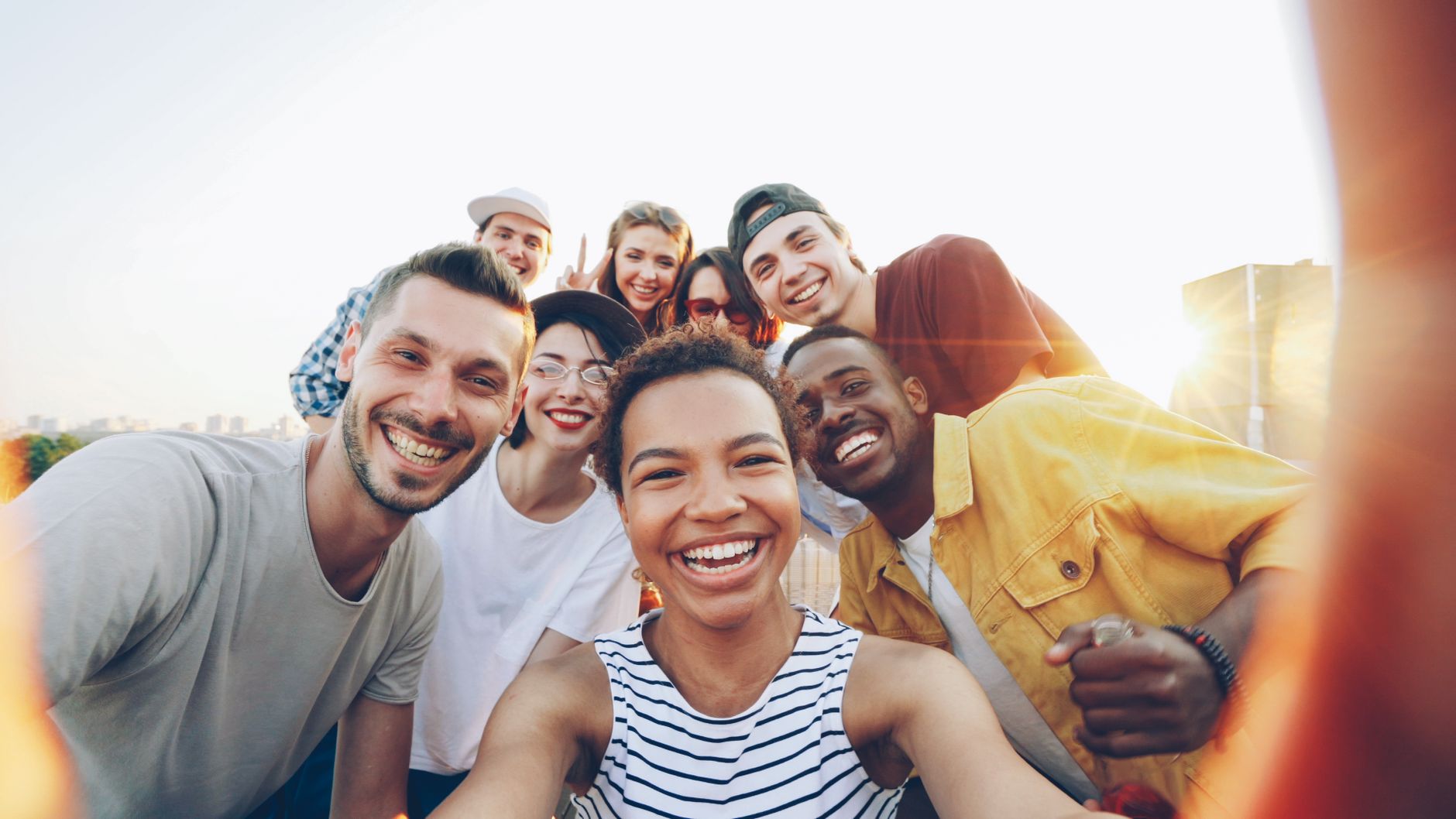 joyful group selfie at sunset outdoors